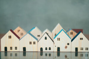 Wooden model houses representing housing demand growth in Utah Valley