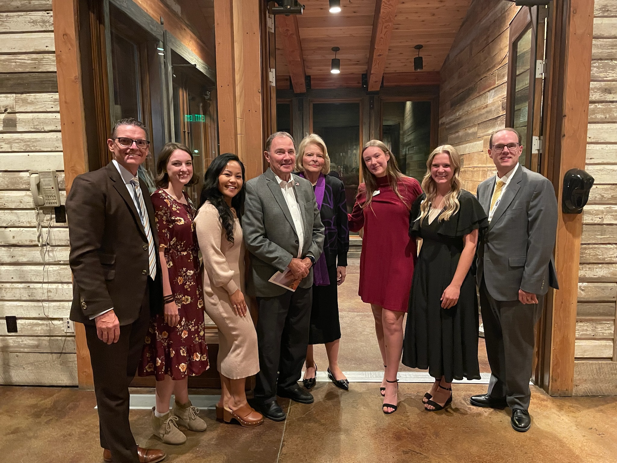 Group of Utah Valley Chamber members standing together at a committee leadership event.